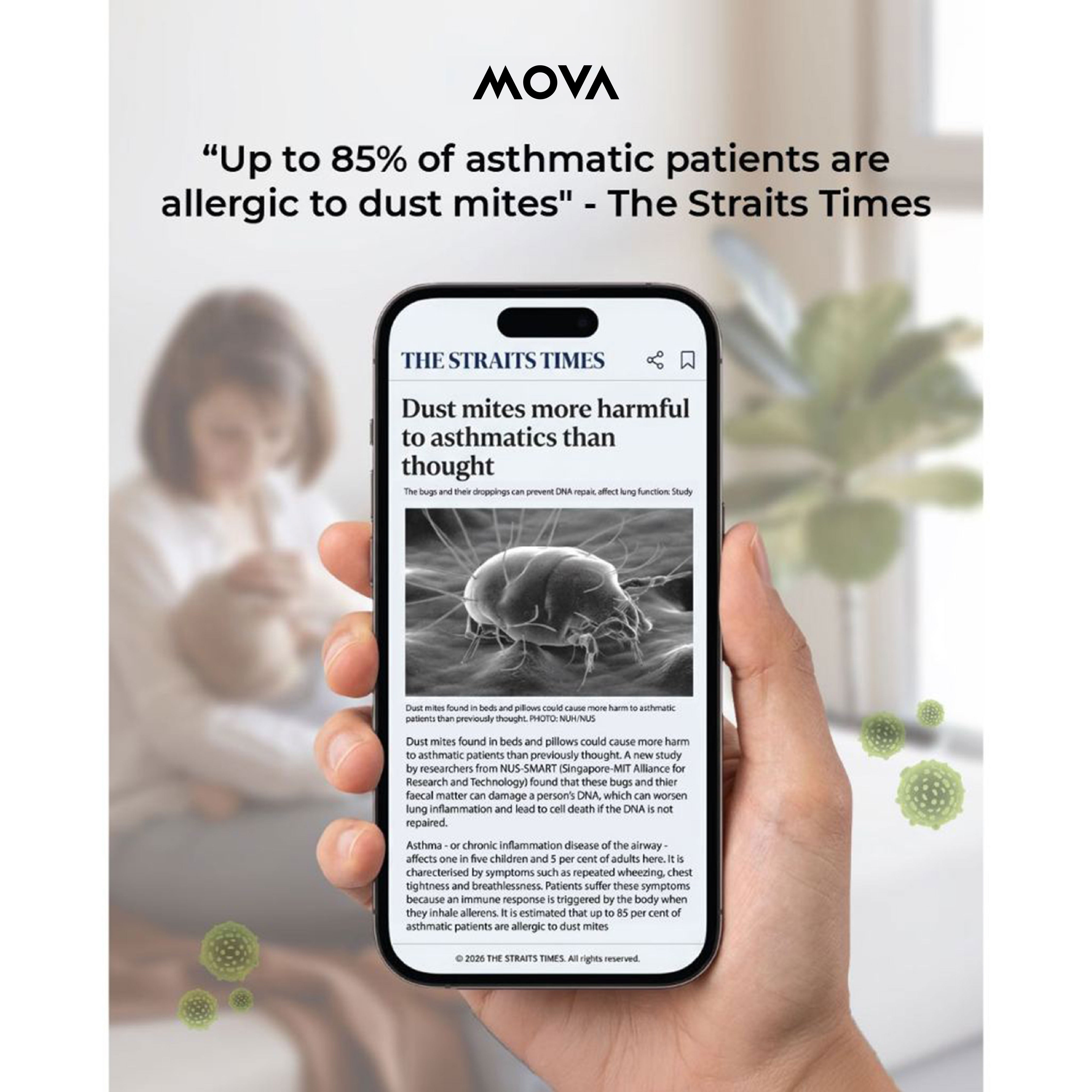 MOVA dust mite vacuum detection article on smartphone screen held in a hand